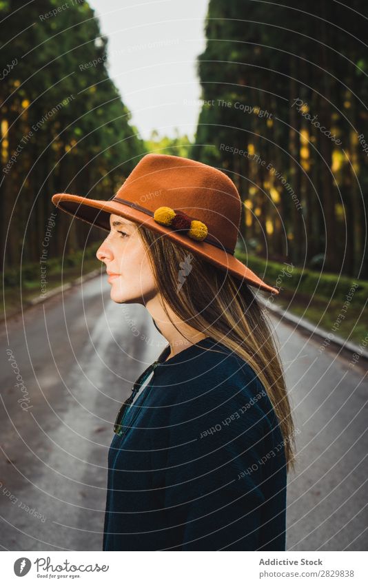 Young woman in sunny forest Woman pretty Forest Green Hat Looking away Nature Environment Natural Seasons Plant Leaf Light Fresh Bright Day Sunlight Wood Growth