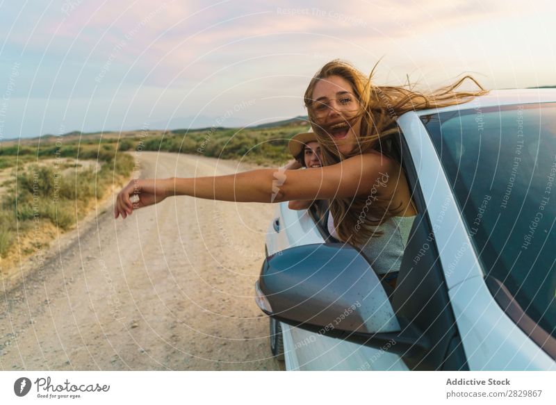 Women hanging out of car Woman Car Nature Looking into the camera Window Field Joy Lifestyle Youth (Young adults) Happy Vacation & Travel Vehicle Human being