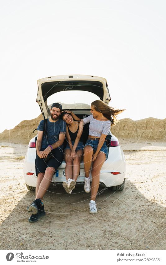 Friends sitting in car trunk Friendship Trunk Together Summer Human being Trip Joy Vacation & Travel Happy Adventure Lifestyle Youth (Young adults) Street