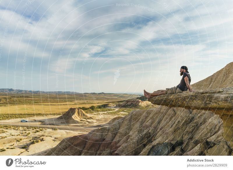 Man relaxing on cliff Cliff Sit Relaxation Edge Vacation & Travel Adventure Rock Mountain Tourist Freedom Vantage point Top Extreme Action Peak Nature Hiking