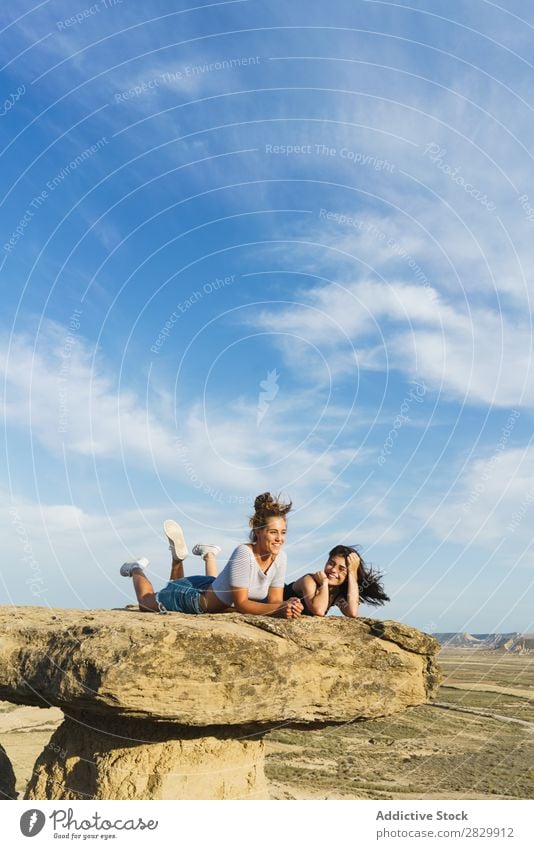 Excited women lying on cliff Woman Cliff Lie (Untruth) Relaxation Vacation & Travel Adventure Rock Mountain Tourist Friendship Together Smiling Happy Excitement