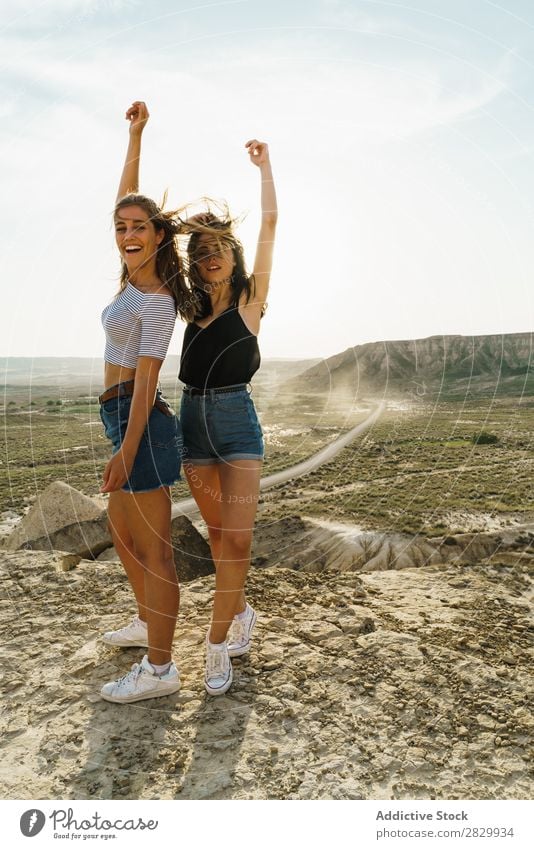 Cheerful women standing on cliff Woman Cliff Excitement Looking into the camera Smiling Embrace Freedom Vacation & Travel Success Top Mountain