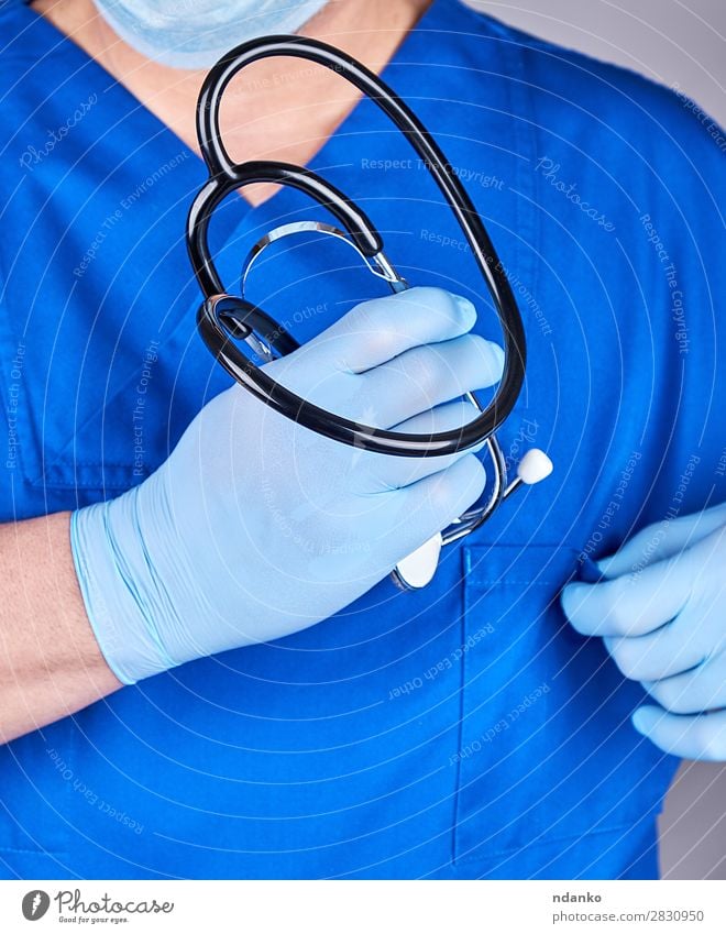 doctor in blue uniform holding a stethoscope Medical treatment Nursing Illness Medication Work and employment Profession Doctor Hospital Tool Human being Man