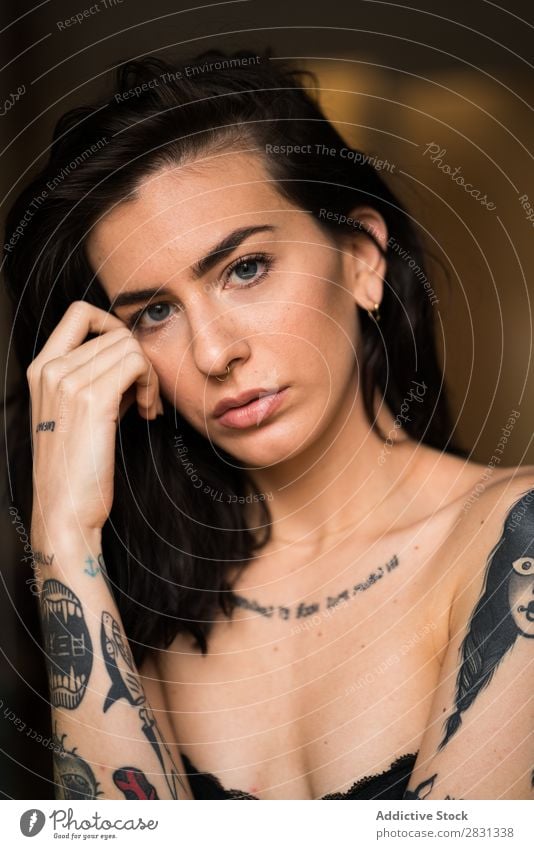 Young brunette with tattooed posing Woman To enjoy Style Easygoing Touch Eroticism Adults Tattooed Portrait photograph Brunette Youth (Young adults)