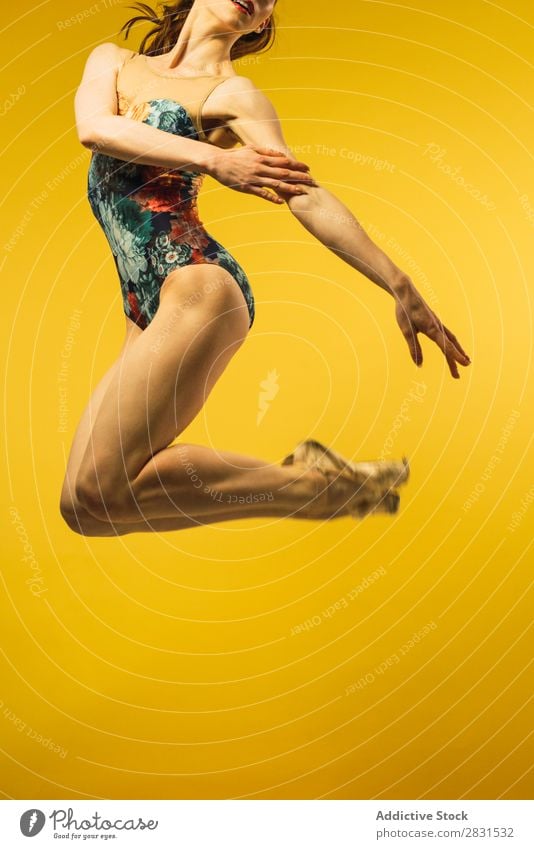 Woman jumping in studio pretty Portrait photograph Youth (Young adults) Jump Ballet Dance Beautiful Adults Posture Smiling Beauty Photography Attractive Model