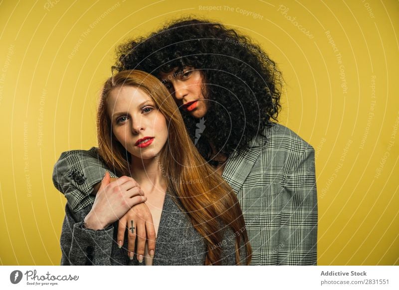 Two women embracing in studio Woman pretty Portrait photograph Couple Homosexual Curly Brunette Alternative lgbt Youth (Young adults) Beautiful Adults Posture