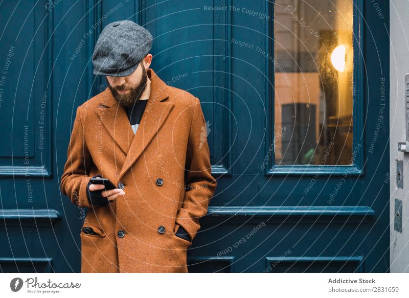 Thoughtful stylish man at door Man handsome City Style Coat Hat Cap Door Considerate Pensive Street Youth (Young adults) Town Lifestyle Easygoing Fashion Adults