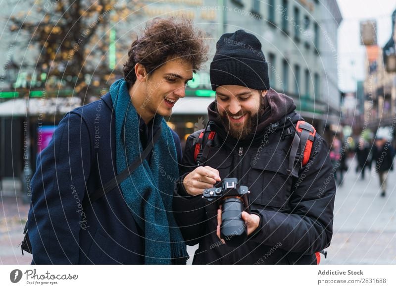 Cheerful men watching camera Man Together Camera Observe Vacation & Travel Tourism Smiling handsome City Street Youth (Young adults) Town Lifestyle Easygoing