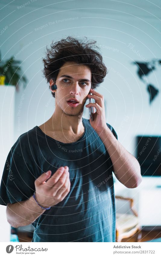 Man talking on phone at home handsome Home To talk PDA Stand Communication Gadget device Youth (Young adults) Portrait photograph Lifestyle Human being