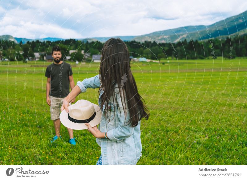 Woman throwing hat on meadow Couple Hat Hill Meadow Joy Nature Summer Human being Man Love Grass Beautiful Together Youth (Young adults) Happy Landscape