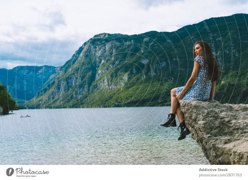 Woman sitting on stone at lake Lake Mountain Stone Sit Nature Summer Water Youth (Young adults) Vacation & Travel Lifestyle Human being Beautiful Landscape Girl