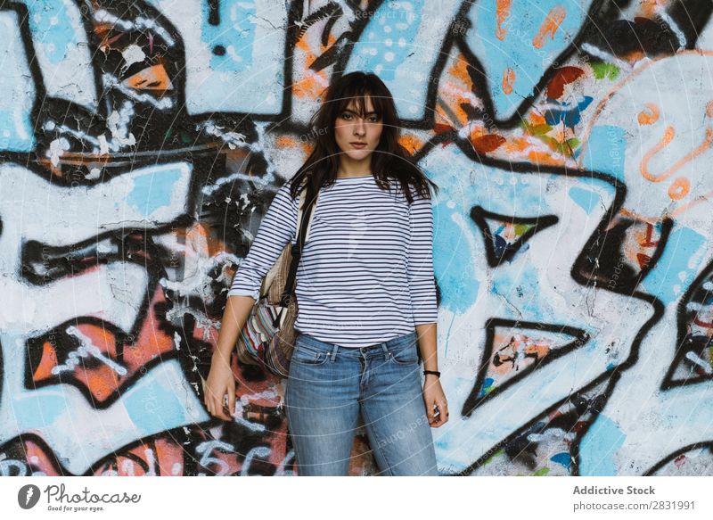 Casual woman on graffiti wall background Human being Easygoing Posture Traveling Graffiti Style Town Beauty Photography Multicoloured Portrait photograph
