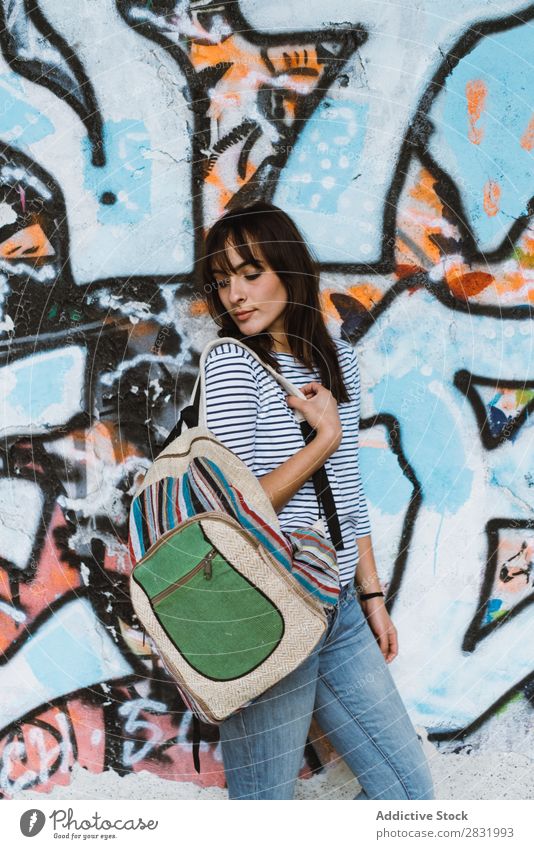 Woman with backpack at graffiti wall City Tourist Backpack Stand Posture Wall (building) Graffiti Art Beautiful Vacation & Travel Street Youth (Young adults)