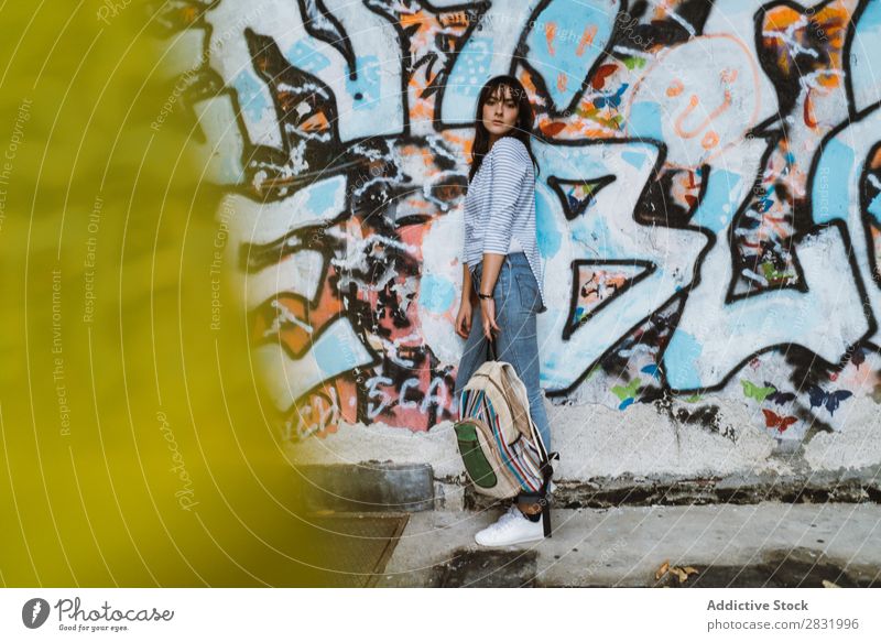 Casual model standing at street Human being Easygoing Posture Wall (building) Self-confident Style Town Accessory Backpack Traveling Graffiti Beauty Photography