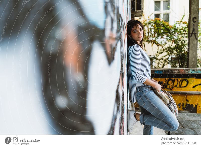Woman leaning on wall looking at camera Human being Easygoing Posture Wall (building) Self-confident Style Town Accessory Backpack Lean Traveling Earnest