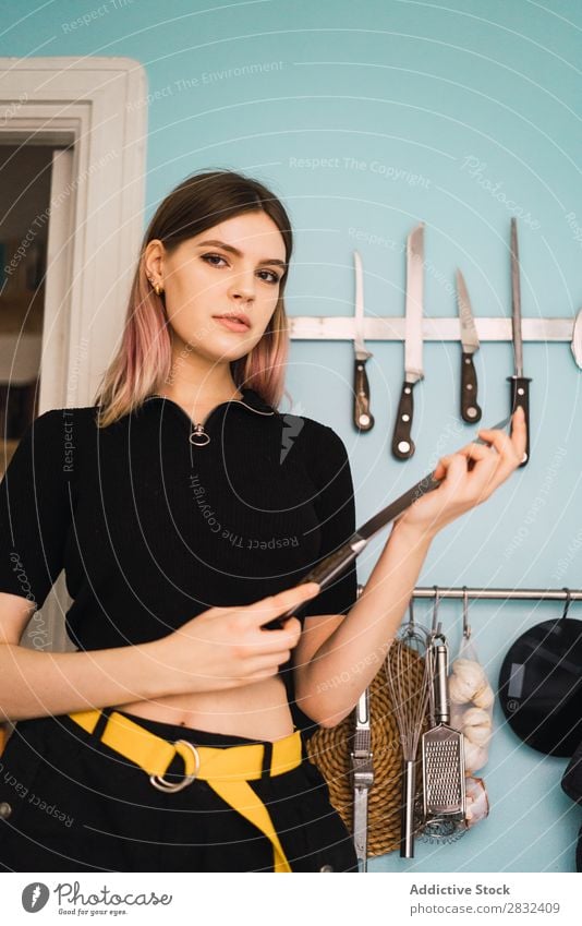 Young woman with kitchen knife Woman pretty Home Youth (Young adults) To enjoy Knives Kitchen Attractive Posture Portrait photograph Beautiful Lifestyle