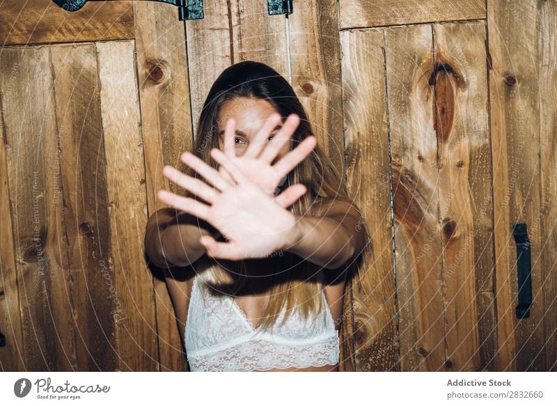 Attractive woman covering face with her hands - a Royalty Free