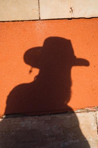 Male shadow with gun on wall Man Cowboy Shadow West Silhouette Wild Western Handgun Contour Hat Wall (building) Bright Risk Sunlight Contrast Dangerous Style