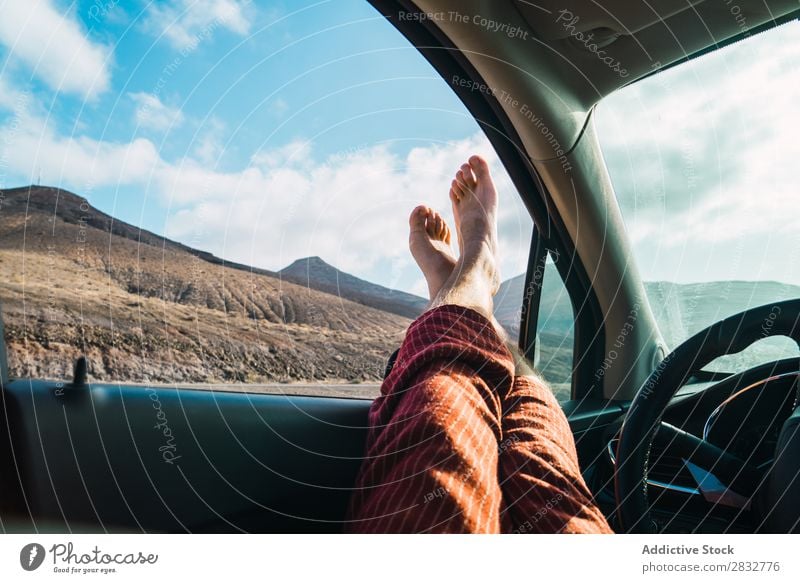 Crop man relaxing in car while traveling Man Car Landscape Window Feet Relaxation Transport Freedom Barefoot Legs Adventure Leisure and hobbies Stick out Lounge