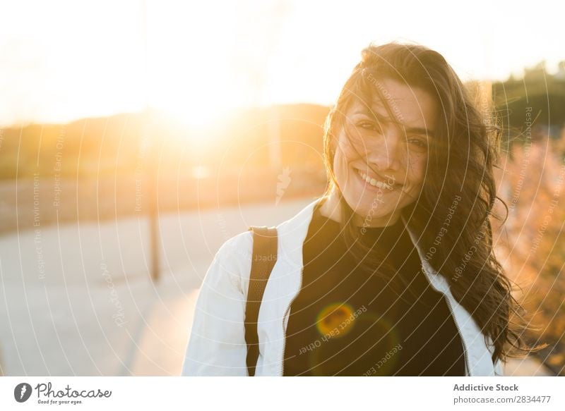 Smiling adorable female in sunlight Woman Posture Hipster Portrait photograph Style To enjoy waving hair Town Cheerful Brunette Self-confident Laughter