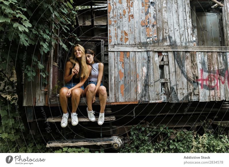 Women embracing in wrecked cabin Woman girlfriends Posture Grunge abandoned Summer Homosexual Building explore Love Couple romantic Together Relationship