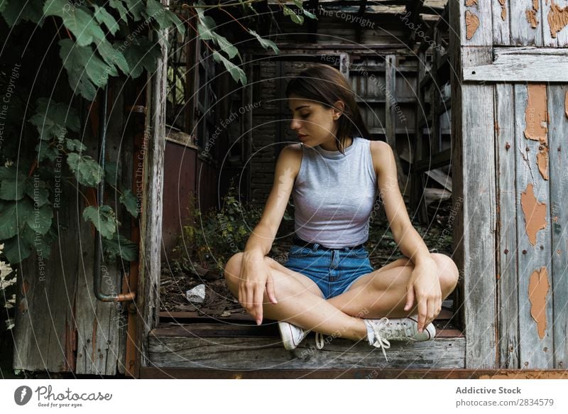 Woman posing in wrecked cabin Posture Grunge abandoned Summer Building explore romantic Sit Weathered Self-confident Exterior shot Storehouse Expressive