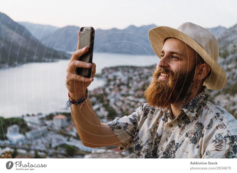 Man browsing phone in mountains Town Mountain River Human being shots Take Tourist Village Vantage point pathway Landscape Vacation & Travel Nature Tourism