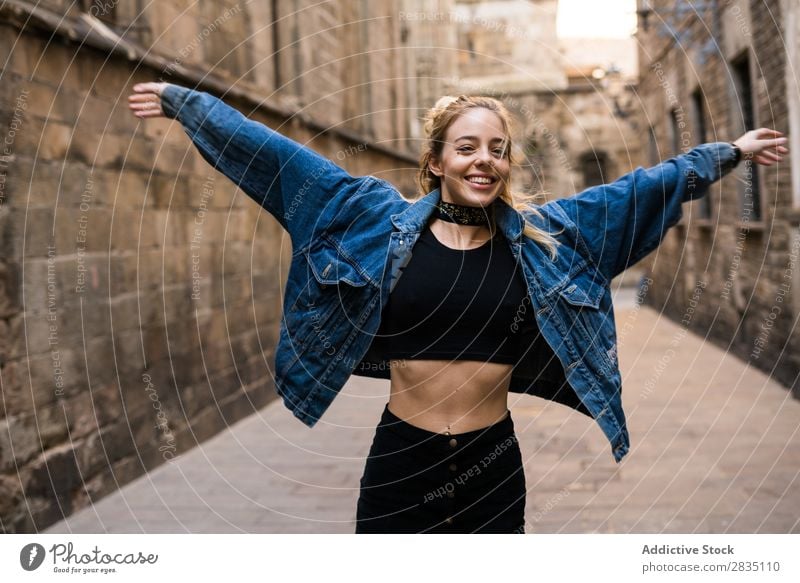 Smiling woman with wide hands Happy Woman Easygoing Street City Town Youth (Young adults) Beautiful Looking into the camera Copy Space Beauty Photography
