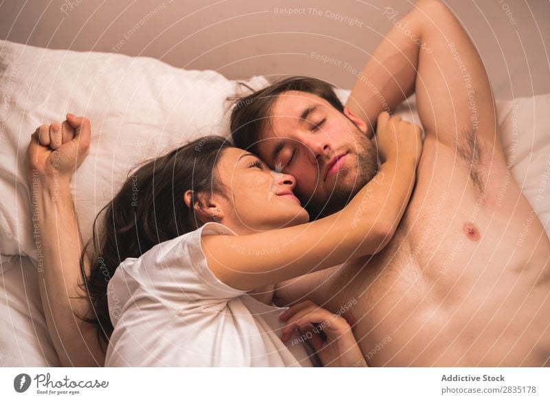Woman looking at sleepy boyfriend Couple Embrace Man Stretching Morning Love Youth (Young adults) Relationship Human being 2 Bed Bedroom Romance Together