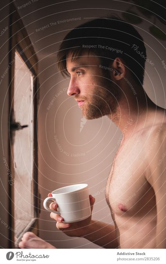 Sleepy man with a cup sleepy Man Cup Morning Considerate Looking away Pensive Mug Hot Drinking Think Breakfast Lifestyle Home Portrait photograph Kitchen