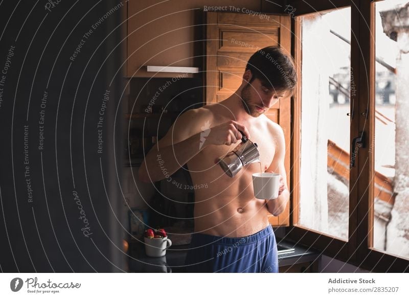 Man pouring a coffee to the mug Cup Morning Filling Considerate Pensive Mug Hot Drinking Think Breakfast Lifestyle Home Portrait photograph Kitchen