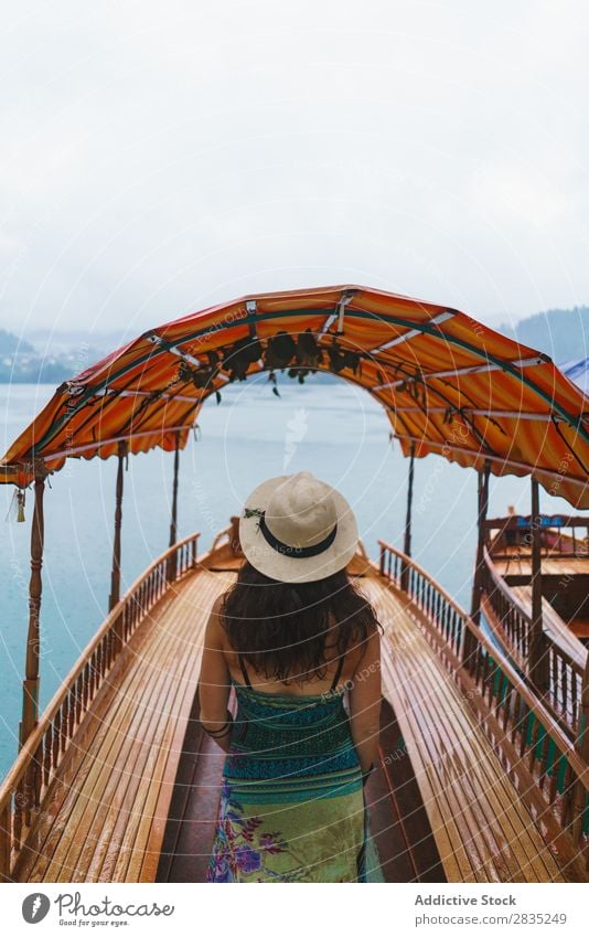 Woman on boat on lake Lake pretty Stand Floating Vessel Hat Coast Vantage point Nature Water Landscape Summer Blue Green Beautiful Scene Vacation & Travel