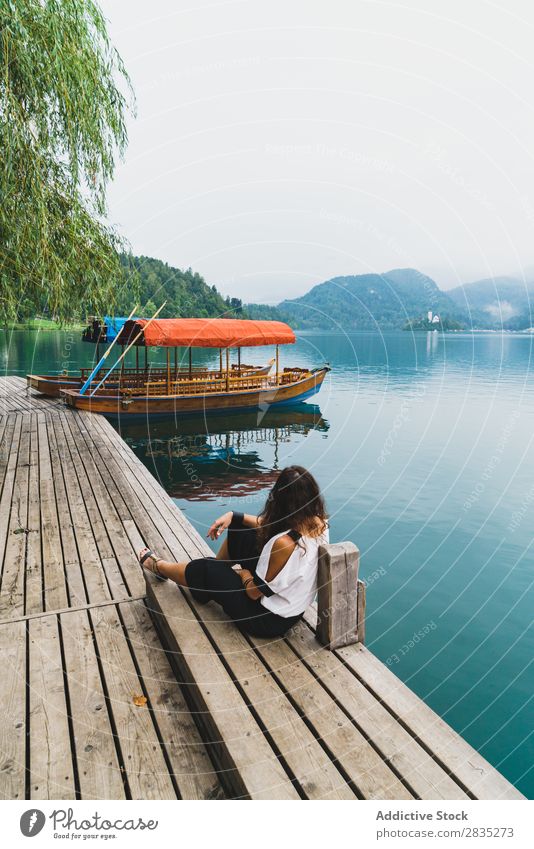 Woman looking at hills on lake Sit Jetty Hill Mountain Lake Coast Vantage point Nature Water Landscape Summer Blue Green Beautiful Scene Vacation & Travel