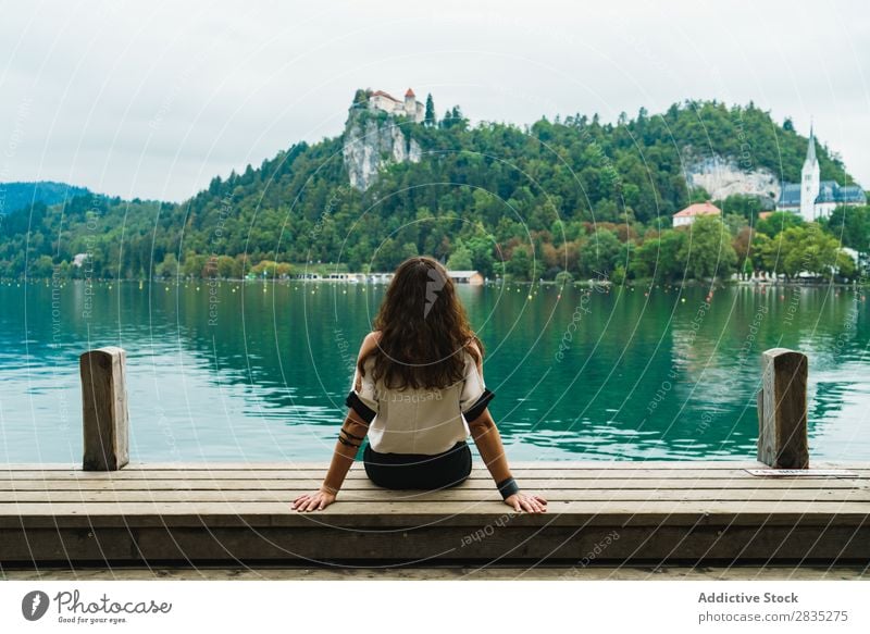 Woman looking at hills on lake Sit Jetty Hill Mountain Lake Coast Vantage point Nature Water Landscape Summer Blue Green Beautiful Scene Vacation & Travel