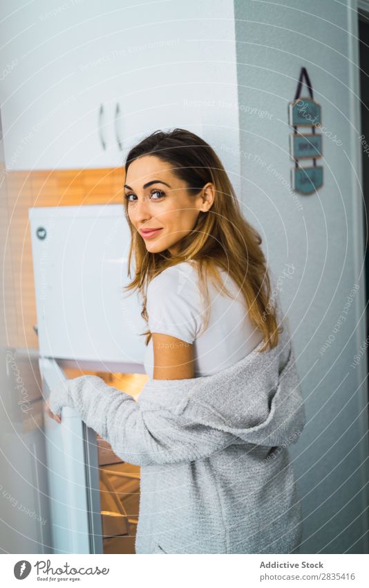 Pretty woman at opened fridge Woman pretty Home Youth (Young adults) Take refrigerator Opening Posture Portrait photograph Beautiful Lifestyle