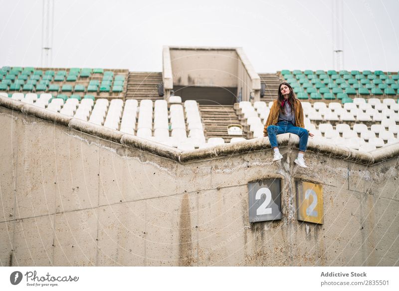 Young cute girl in an abandoned stadium Youth (Young adults) attitude Cute Beautiful Girl Stadium Auditorium Cold Winter Airplane seat Portrait photograph