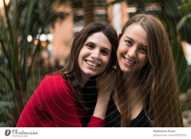 Portrait of two cheerful women Woman pretty Friendship Joy Looking into the camera Together Walking Cheerful Smiling Beautiful Portrait photograph Posture