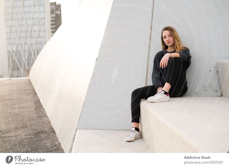 Woman sitting on concrete block Sit Concrete Block Stairs Building Dream Considerate Pensive Looking into the camera pretty Youth (Young adults) Beautiful