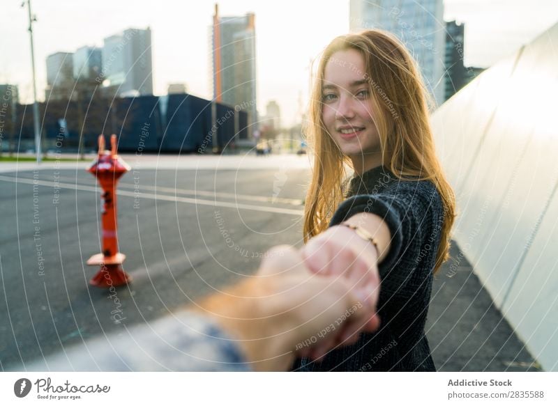 Young cute woman. Follow me concept. follow me gesture smiling cheerful dreamy building hand street city urban looking at camera pretty young beautiful female