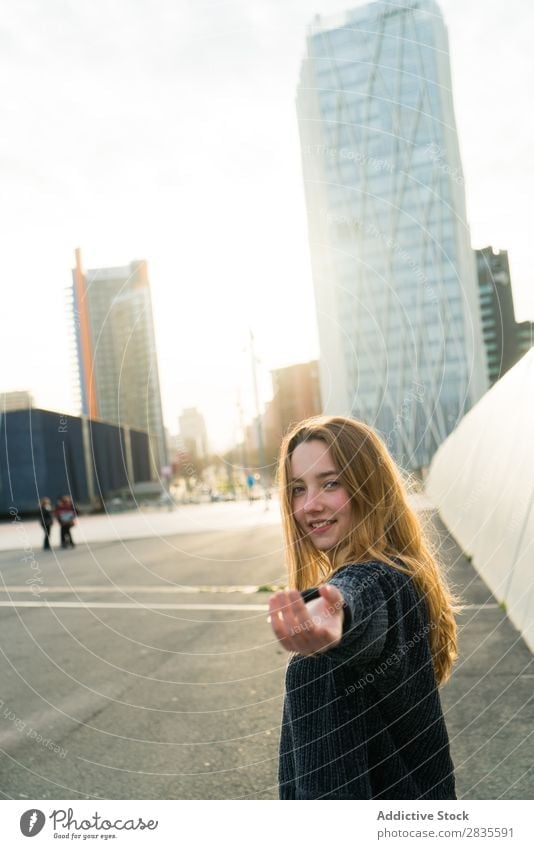Woman gesturing follow me Gesture Smiling Cheerful Dream Building Hand Street City Town Looking into the camera pretty Youth (Young adults) Beautiful Sweater