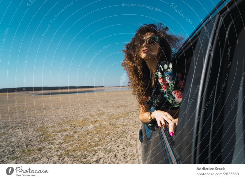 Woman enjoying riding car in desert Car Freedom Wind Window Speed Beauty Photography Vehicle waving hair Transport Joy Environment Vacation & Travel Summer