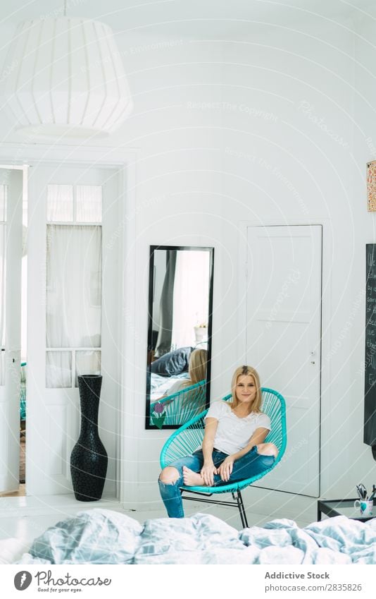 Young blonde woman sitting in chair Woman pretty Home Youth (Young adults) Blonde Looking into the camera Sit Chair Beautiful Lifestyle Beauty Photography