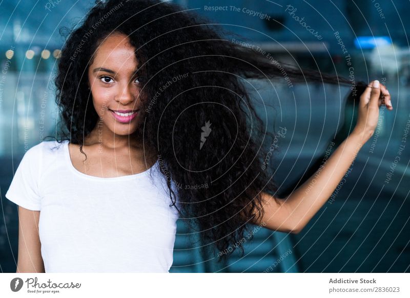 Woman playing with hair in mall pretty Youth (Young adults) Portrait photograph Looking into the camera Hair Playful Black African City Mall Town Head Beautiful