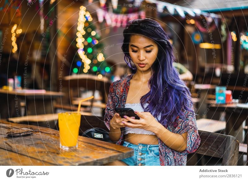 Woman with smartphone in cafe pretty Youth (Young adults) Beautiful Portrait photograph Juice Drinking PDA using browsing Café Hair Purple asian eastern Fashion