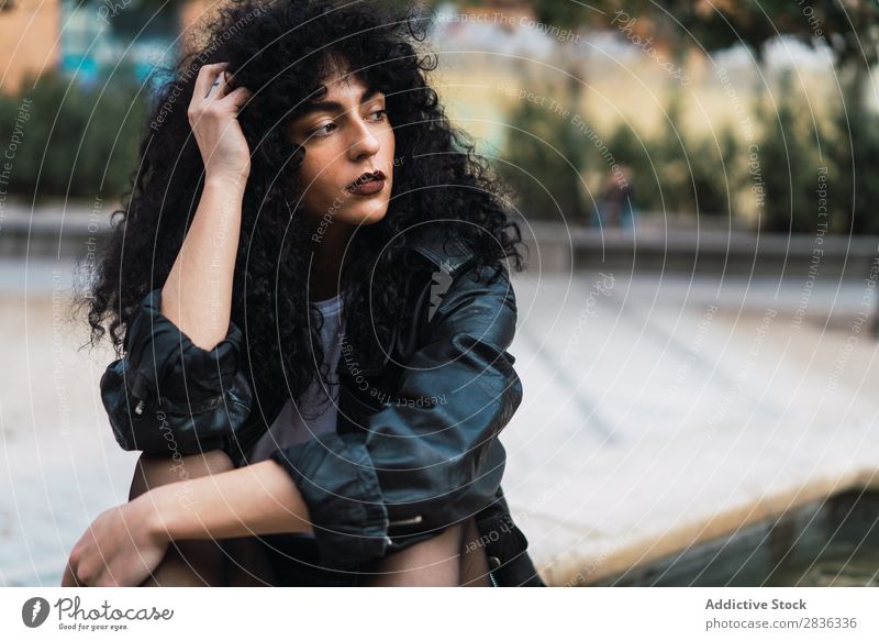 Curly woman posing in city Woman Attractive City fashionable Brunette Looking away Jacket Fashion Youth (Young adults) Beautiful pretty Street Model Style Hair