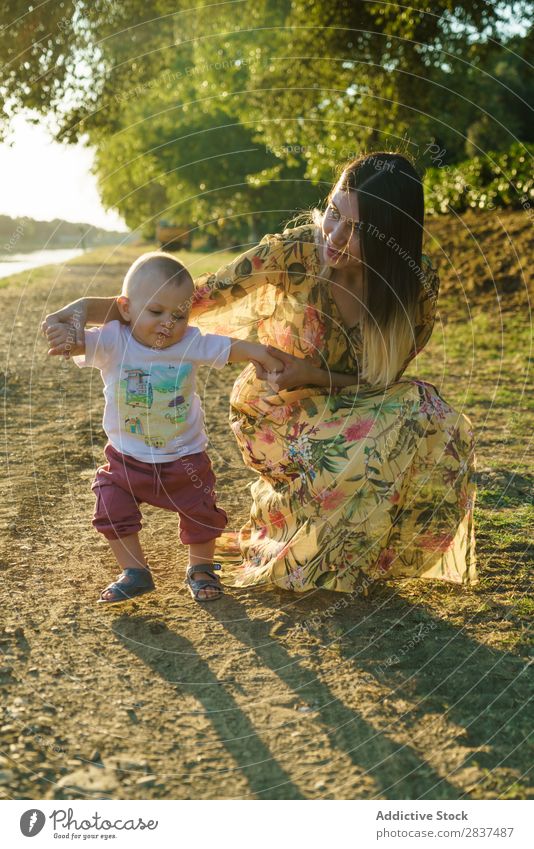 Mother holding walking child Child Park stepping School Walking Support Sunbeam Family & Relations Happy Human being Woman Happiness Summer Lifestyle Love