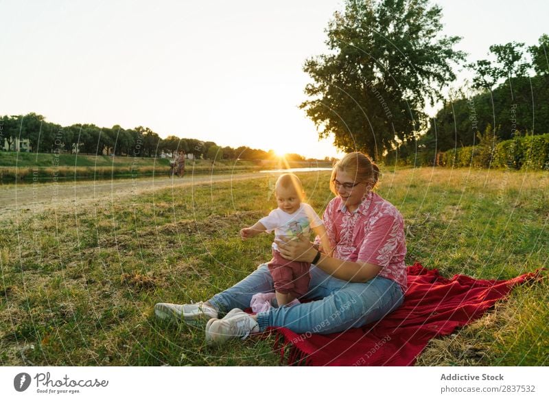 Woman with child on lawn Mother Child Park Lawn Green Sunbeam Happy Human being Happiness Summer Lifestyle Love same gender parents Homosexual Couple