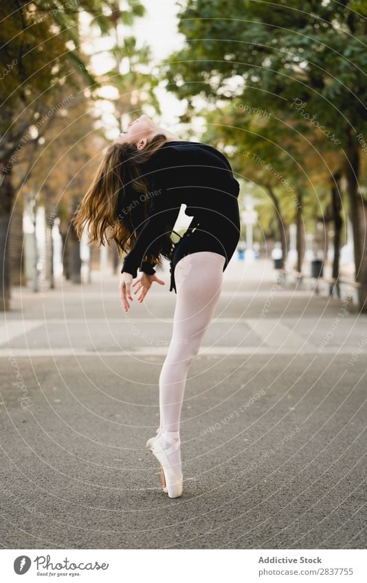 Side view of female ballet dancer Woman Ballet Flexible Town Sports Youth (Young adults) Park gymnastic Movement Jetty Dance Performance Posture City Action Art