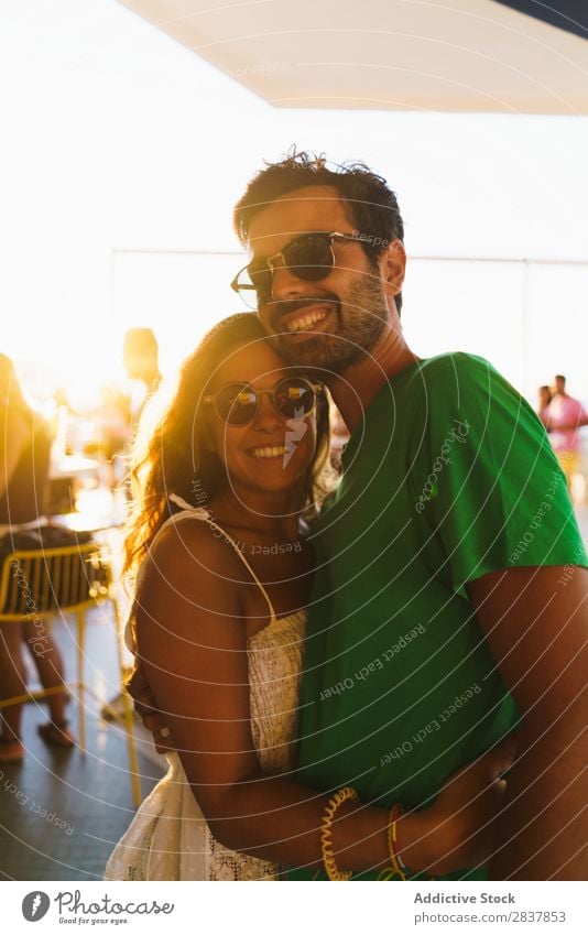 Cheerful people embracing in sunlight Couple Sunlight Posture Happiness Ethnic Together Event romantic Summer Feasts & Celebrations Beauty Photography Light
