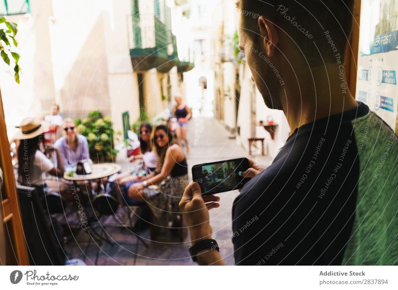 Man taking photo of friends Human being Friendship Street Café Traveling Summer Memory Photography PDA Restaurant Illustration Technology Together Modern